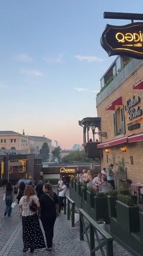 Baku's Sabail district at dusk: cobblestones, bold cars, local color