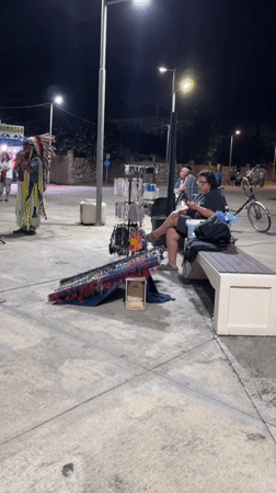 Flute performance in Native American costume draws crowd in Ureki