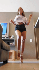 Woman practices ballet, plays with cat in Buenos Aires apartment
