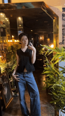 Woman takes selfies during cocktail hour at Seoul restaurant