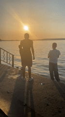 Sunset on a Votkinsk pier, figures watching the water