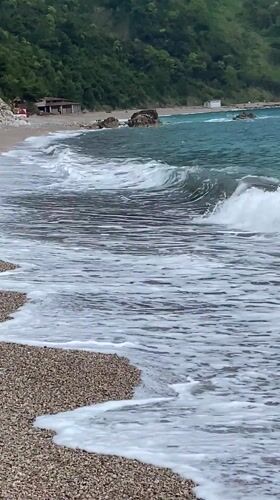 Peaceful morning captured at Montenegro's Prijevor beach with mountains