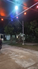 Evening gathering at illuminated outdoor cafe in Lhokseumawe