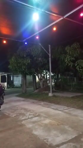 Evening gathering at illuminated outdoor cafe in Lhokseumawe