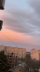Sunset observed over Burgas cityscape with pink-grey sky