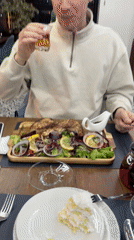 Man dines on grilled fish at T'bilisi restaurant
