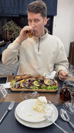 Man dines on grilled fish at T'bilisi restaurant