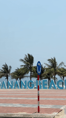 Early morning beach scene captured at Da Nang sign
