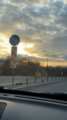 Dashboard camera captures highway sunset scene near Mshaga, Russia