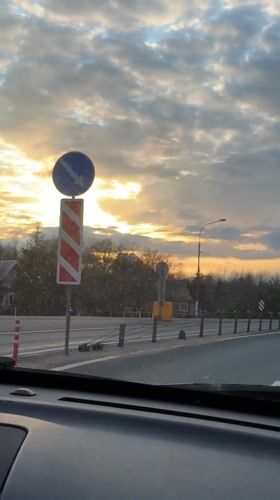Dashboard camera captures highway sunset scene near Mshaga, Russia