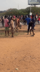 Large crowd gathers on dusty ground in Abuja
