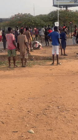 Large crowd gathers on dusty ground in Abuja