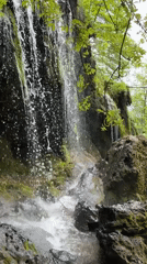 Waterfall and monastery documented in Ribaritsa, Bulgaria countryside
