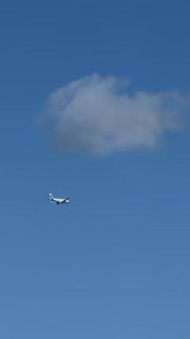 A white airplane flies across a clear blue sky. A single, small white cloud is visible in the upper left portion of the frame. The airplane moves from left to right, appearing relatively small against the vast sky, suggesting it is at a high altitude or distant. The sky is bright and blue, indicating fair weather. No other objects, people, or text are visible in the video.