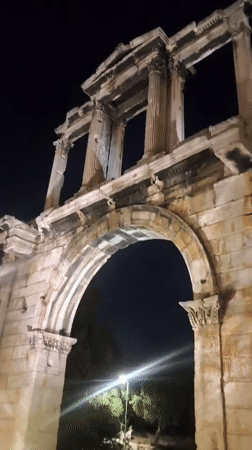 Nighttime stroll past Hadrian's Arch and Athens monuments