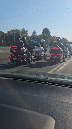Loaded touring bikes stopped in Brest traffic on a sunny day