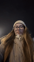 Woman records nighttime selfies in Saint Petersburg parking area