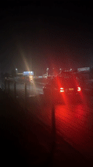 Wet night streets in Uyo's Urua Ekong market area