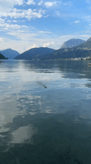 RC boat on a clear alpine lake near Mendrisio, Switzerland