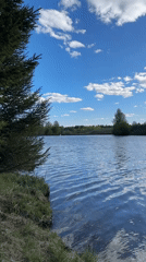 Woman enjoys fishing trip at Russian lake on sunny day