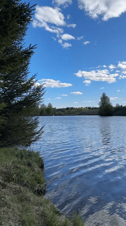 Woman enjoys fishing trip at Russian lake on sunny day