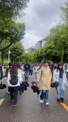 Students gather at Chongqing tech zone campus on overcast day