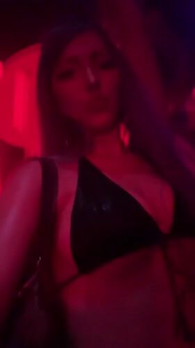 Late-night club scene in Milan, deep into the set.