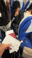 Red passport and boarding passes held together before a flight