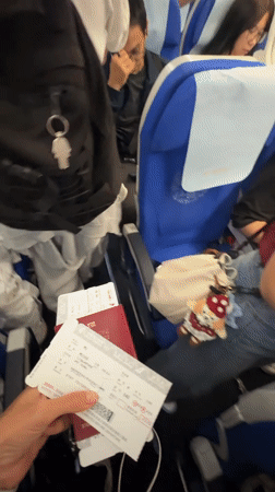 Red passport and boarding passes held together before a flight