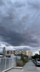 Storm rolls over a city as night falls
