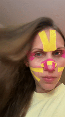 Woman applies kinesiology tape to face in Fethiye home