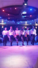 Synchronized folk-style dance performance under colorful stage lights, Beşiktaş