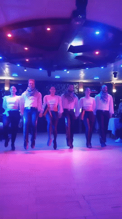 Synchronized folk-style dance performance under colorful stage lights, Beşiktaş