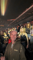 Live concert performance captured with rapper, audience, vehicle backdrop