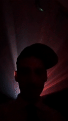 Person silhouetted against pulsating lights in Buenos Aires dawn