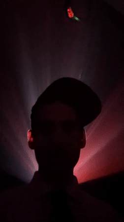 Person silhouetted against pulsating lights in Buenos Aires dawn