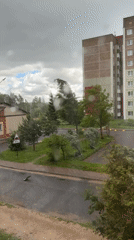 Heavy storm batters residential area, trees bend in high winds