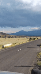 Road trip through Armenian plains toward a snow-capped peak
