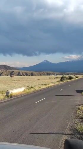 Road trip through Armenian plains toward a snow-capped peak