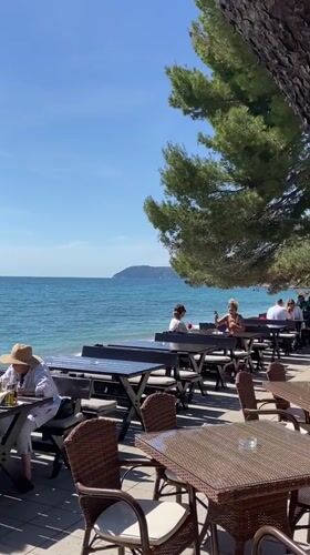 Sunny afternoon dining scene documented along Montenegro's Adriatic coast