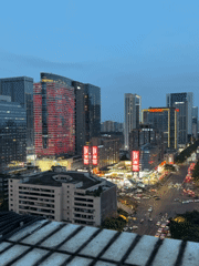 Dusk cityscape captured in Jinjiang District featuring illuminated buildings