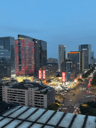 Dusk cityscape captured in Jinjiang District featuring illuminated buildings