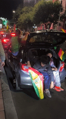 Nighttime street celebrations with Bolivian flags sweep La Paz
