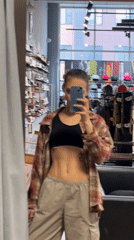 Woman takes mirror selfie in clothing store in Krasnoyarsk