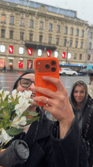 Woman takes rainy day selfie with flowers in Saint Petersburg