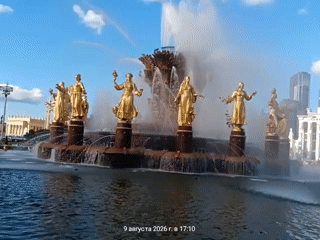 Ornate golden fountain spraying water in a grand public plaza