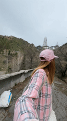 Woman takes selfie on cracked path in Almaty