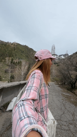 Woman takes selfie on cracked path in Almaty