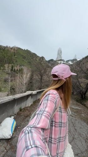 Woman takes selfie on cracked path in Almaty