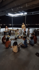 Children gather under supervision in Phan Rang patio area